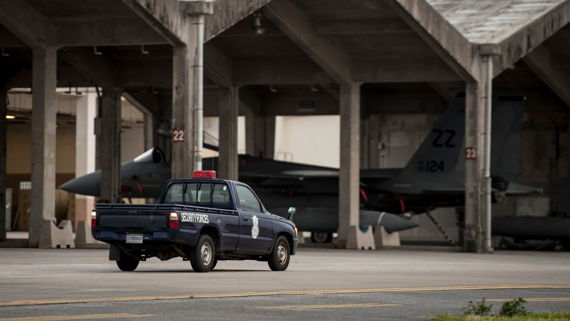 A U.S. Air Force 18th Security Forces Squadron patrol vehicle guards F-15 Eagle fighter aircraft parked on the flightline Sept. 27, 2016, at Kadena Air Base, Japan. Response force members of the 18th SFS guard Kadena’s aircraft and watch for unauthorized activity or personnel both day and night, ensuring uninterrupted aircraft operations.  (U.S. Air Force photo by Senior Airman Peter Reft)