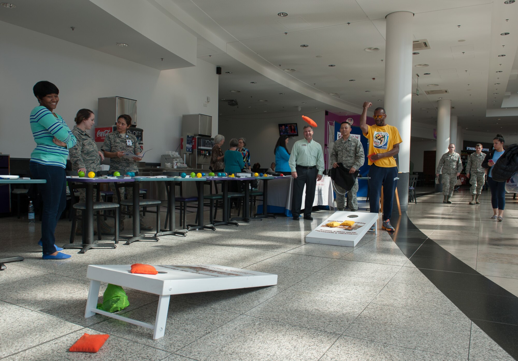 A passerby stops to throw a bean bag during a suicide prevention fair Sept. 22, 2016, at Ramstein Air Base, Germany. Many people stopped to participate and learn about what was offered.