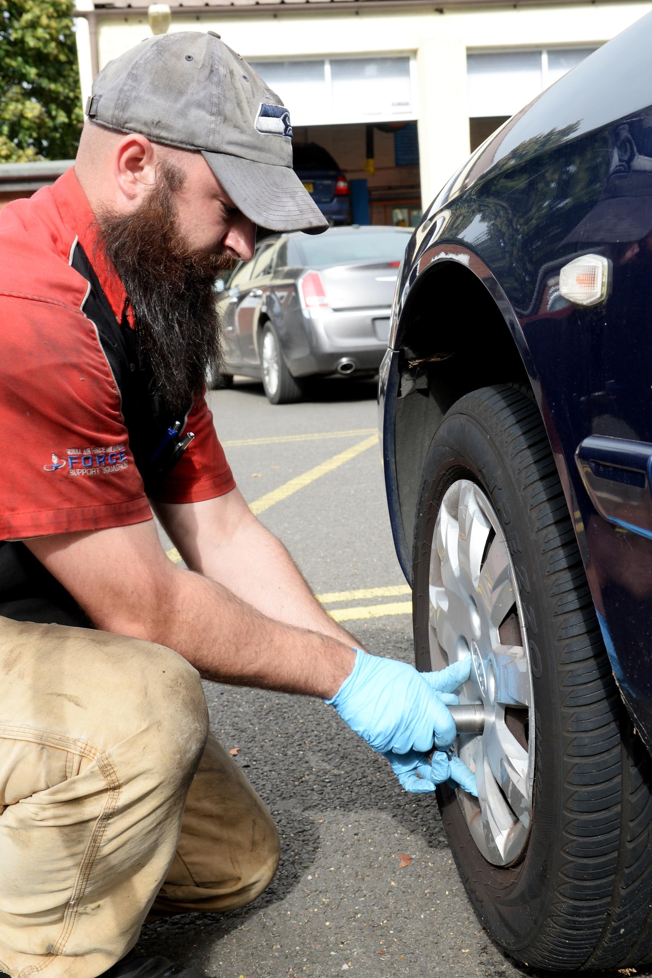 Jacob Crowell, 100th Force Support Squadron Auto Hobby Shop automotive technician, changes a tire Sept. 28, 2016, on RAF Mildenhall, England. Even if it’s something as simple as changing a flat tire, being prepared can save lives.  For more information and a full listing of recommended items go to www.ready.gov/build-a-kit. (U.S. Air Force photo by Airman 1st Class Tenley Long)