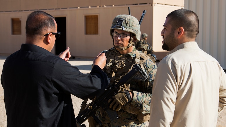 A student with Infantry Officer Course speaks to role-players at Range 220, the Combat Center’s largest military operations on urbanized terrain facility, Sept. 22, 2016, as part of Exercise Talon Reach. Officers awaiting training at Marine Corps Communication-Electronics School and Marine Corps Intelligence School also participated in the exercise, for the first time, to create a mutually beneficial learning environment. 