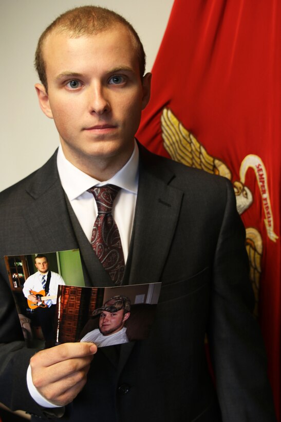 Connor Anteau holds up pictures of his dramatic weight loss transformation after giving his oath of service August 25, 2016 in Ann Arbor, Michigan. Antea is a Gibraltar, Michigan native who lost nearly 60 pounds to join the United States Marine Corps. (U.S. Marine Corps photo by Sgt. J. R. Heins/ Released)