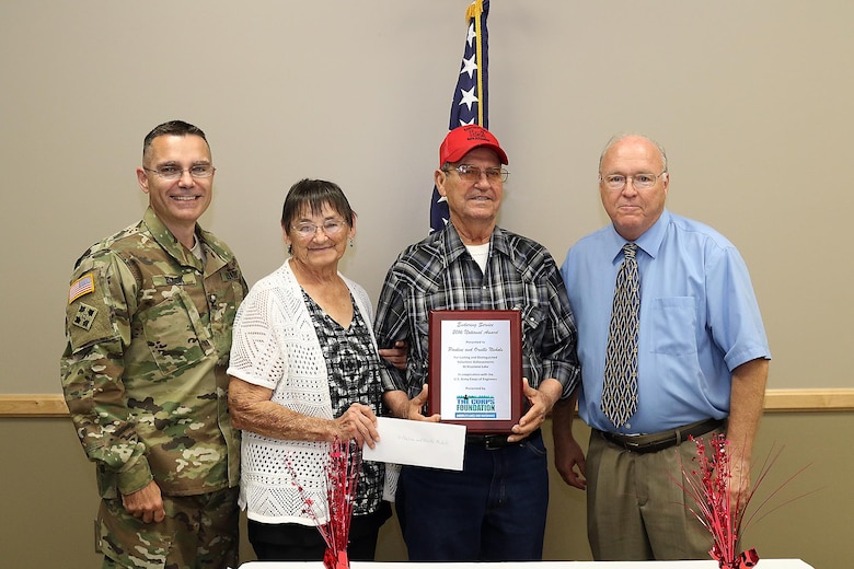 Col. Christopher Hussin, Commander, Tulsa District, U.S. Army Corps of Engineers joins Greg Miller, Chairperson Board of Directors, The Corps Foundation, in presenting Orville and Pauline Nichols with the “Volunteer Enduring Service Award,” Sept. 22, at the Case Community Center, Sand Springs, Okla.  The Nichols received the national award for their contribution of over 26,000 hours of volunteer work to Keystone Lake.