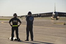 Staff Sgt. Dylan Wall, 5th Aircraft Maintenance Squadron dedicated crew chief (left), and Robert Crane, 5th Logistics Readiness Squadron vehicle management flight chief, watch as the B-52H Stratofortress Ghost Rider taxis to the alternate parking area at Minot Air Force Base, N.D., Sept. 27, 2016. Crane was the primary crew chief on Ghost Rider when it was stationed here in the 90s. (U.S. Air Force photo/Airman 1st Class J.T. Armstrong)