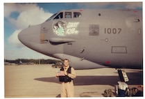 Capt. Doug Warnock, 20th Expeditionary Bomb Squadron, holds an American flag in front of The B-52H Stratofortress 61-007, aka Ghost Rider, at Diego Garcia, July 2002. Warnock now serves as the 5th Bomb Wing operations group commander. (Courtesy Photo)