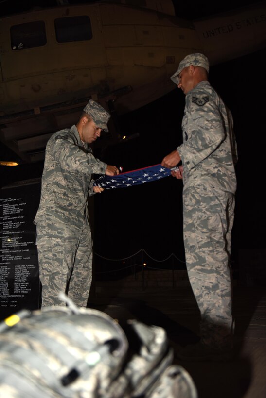U.S. Air Force Staff Sgt. Tyler Wiseman, 17th Security Forces Squadron Military Working Dog kennel master, and Staff Sgt. Mark Riley, 17th SFS unit trainer, fold the American flag during the Jacobson Memorial Ruck March at the Mathis Field Vietnam Memorial, San Angelo, Texas, Sept. 28, 2016. Members from Goodfellow Air Force Base rucked 12-miles in honor of Airman 1st Class Elizabeth Jacobson’s death in Operation Iraqi Freedom in 2005. (U.S. Air Force photo by Airman 1st Class Caelynn Ferguson/Released)