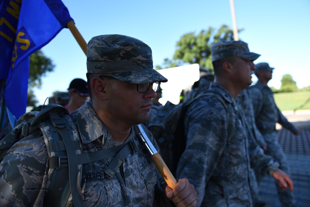 U.S. Air Force Airman 1st Class Adrian Varela, 17th Security Forces Squadron entry controller, carries the 17th SFS guidon during the Jacobson Ruck March outside the Jacobson Gate on Goodfellow Air Force Base, Texas, Sept. 28, 2016. Varela carried the guidon for the 12-mile march. (U.S. Air Force photo by Airman 1st Class Caelynn Ferguson/Released)