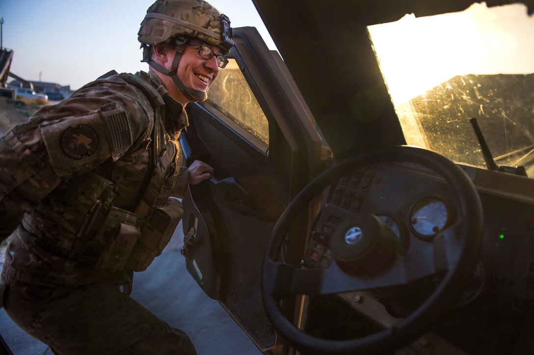 Air Force Senior Airman Jay Prather smiles as he gets into a mine-resistant, ambush-protected vehicle before moving out on a flightline security patrol at Bagram Airfield, Afghanistan, Sept. 27, 2016. Prather is a quick reaction force member assigned to the 455th Expeditionary Security Forces Squadron. Air Force photo by Senior Airman Justyn M. Freeman