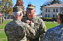 Maj. Gen. Nickolas Tooliatos receives the Distinguished Service Medal from Maj. Gen. Peter Lennon, deputy commanding general (support), U.S. Army Reserve Command, as part of a retirement ceremony for Tooliatos, who retired after 36 years of service to the Army Reserve, Sept. 25, Moffett Field, Mountain View, Calif. (U.S. Army Reserve Photo by Capt. Alun Thomas)