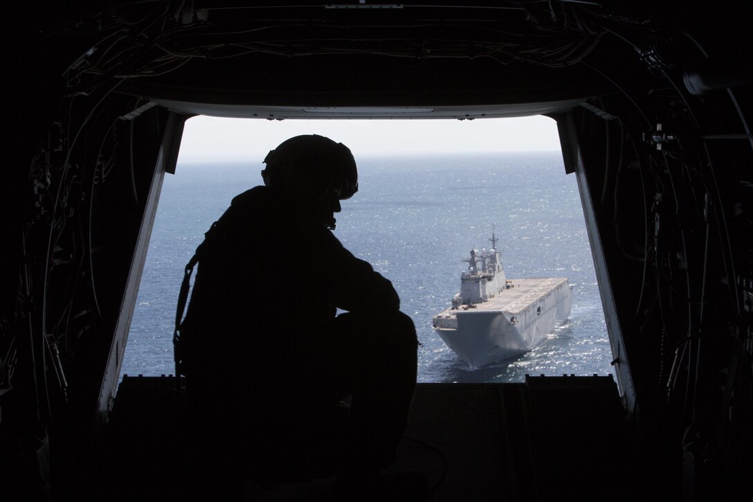 U.S. Marine Corps Sgt. Chad Tompkins Jr., a crew chief with Marine Medium Tiltrotor Squadron 266, Special Purpose Marine Air-Ground Task Force-Crisis Response-Africa, observes out back of an MV-22B Osprey during deck landing qualifications aboard Spanish amphibious assault ship Juan Carlos I in the Gulf of Cadiz, Spain, Sept. 14, 2016. SPMAGTF-CR-AF Marines conducted deck landing qualifications aboard the Juan Carlos I to further enhance bilateral cooperation and interoperability between the U.S. and Spain. 