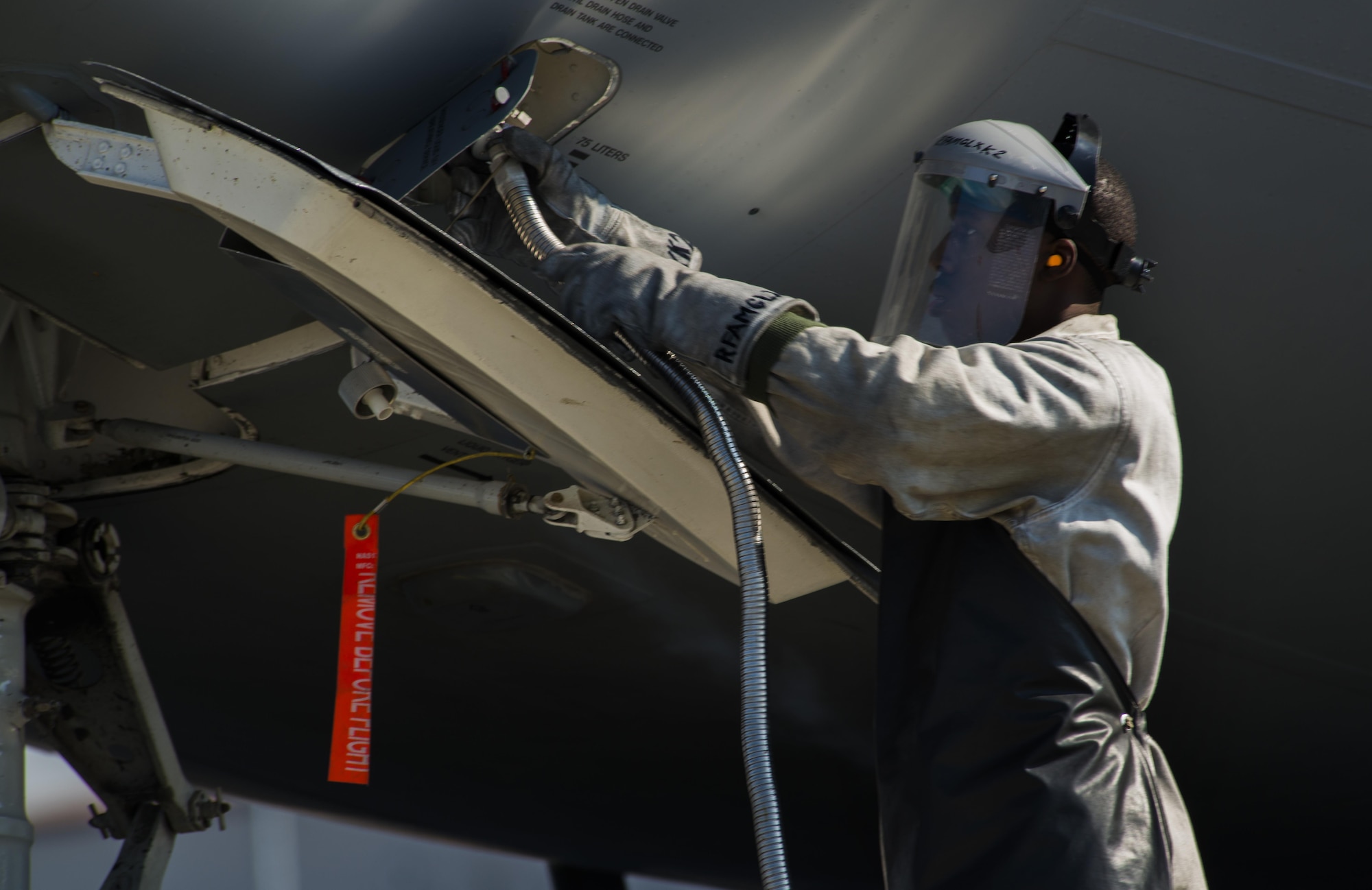 Senior Airman Christian Sharpe, 721st Aircraft Maintenance Squadron aerospace maintenance technician, attaches a hose to a C-17 Globemaster III Sept. 22, 106 at Ramstein Air Base, Germany. Sharpe was refilling the liquid oxygen in this aircraft, which is a source of breathing oxygen for pilots and aircrew at high altitudes. (U.S. Air Force photo/Senior Airman Tryphena Mayhugh)