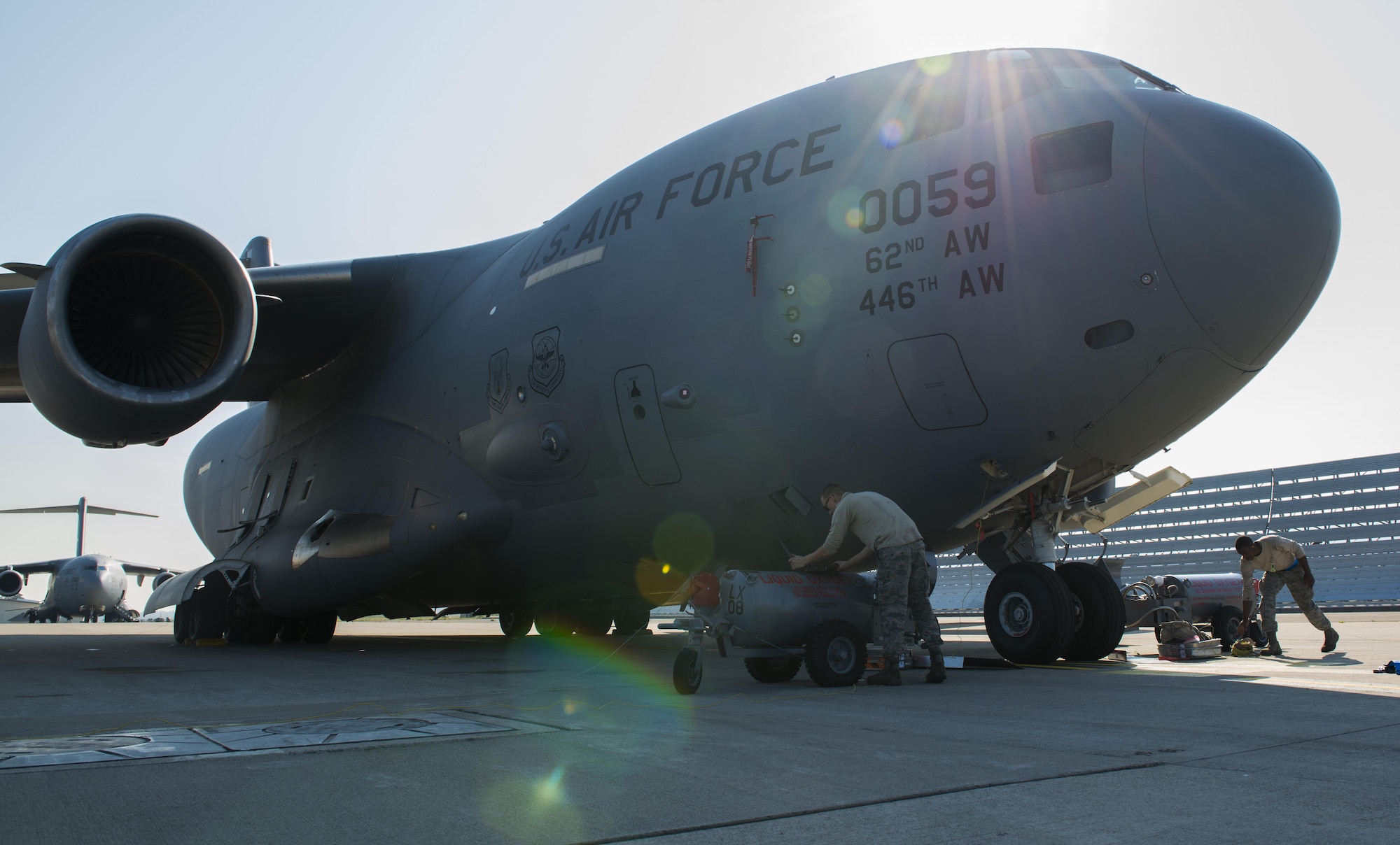 Airmen form the 721st Aircraft Maintenance Squadron service liquid oxygen for a C-17 Globemaster III Sept. 22, 2016 at Ramstein Air Base, Germany. This aircraft had almost depleted its liquid oxygen and required two pumps to refill it instead of the usual one. (U.S. Air Force photo/Senior Airman Tryphena Mayhugh)