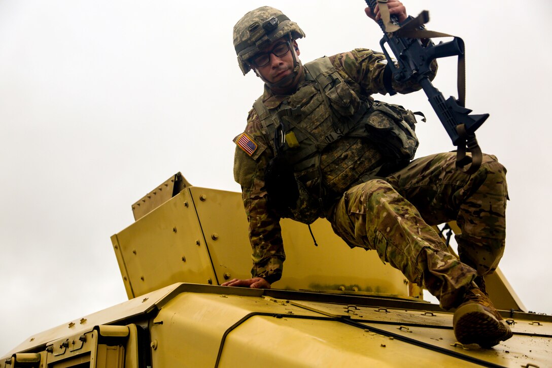 Army Sgt. 1st Class Ilker Irmak dismounts a vehicle during a marksmanship exercise at the Army 2016 Best Warrior Competition at Fort A.P. Hill, Va., Sept. 28, 2016. The annual weeklong event tests 20 soldiers from 10 major commands on their physical and mental capabilities. Army photo by Pfc. Fransico Isreal