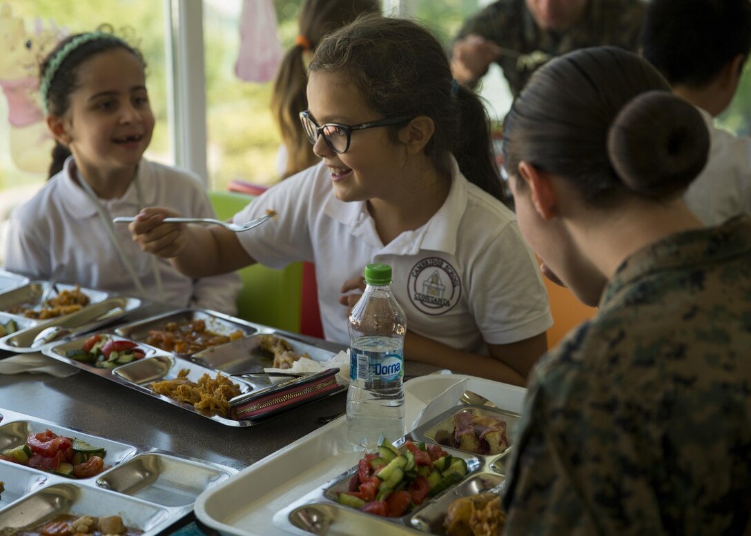 Women with a U.S. Marine Female Engagement Team operating in Europe interact with students at the Cambridge School of Constanta, Romania, 28 Sept., 2016.  The Marines spent two weeks doing military-to-military and military-to-civilian engagements to enhance regional security and stability. (U.S. Marine Corps photo by Sgt. Michelle Reif)