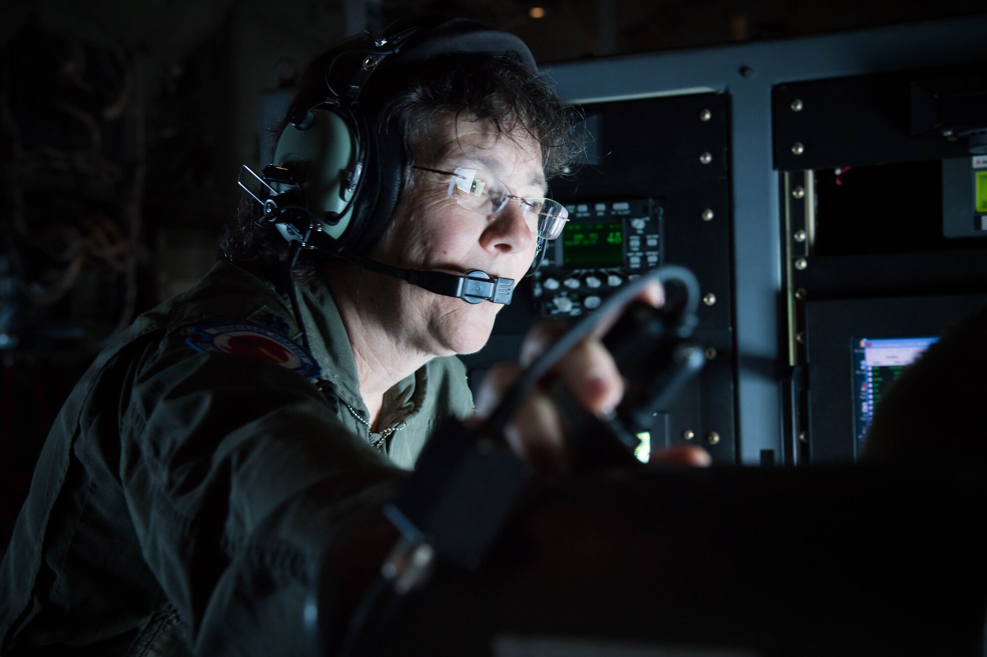 Lt. Col. Valerie Hendry, 53rd Weather Reconnaissance Squadron aerial reconnaissance weather officer instructs a new ARWO during the final flight of her career.(U.S. Air Force photo/Senior Airman Heather Heiney) 