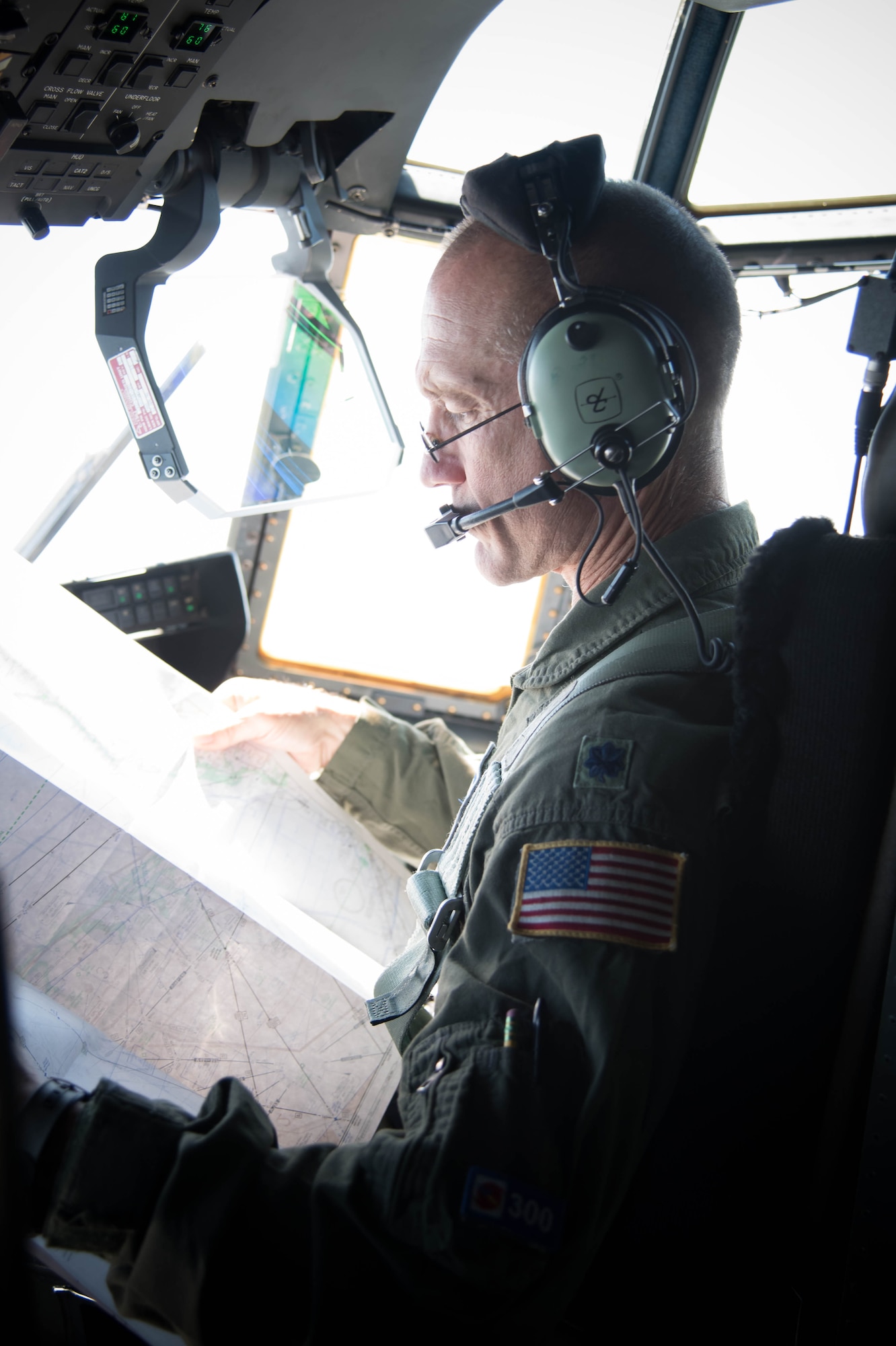 Lt. Col. Troy “Bear” Anderson, 53rd Weather Reconnaissance Squadron pilot looks at a topographical map of the area during the final flight of his Air Force career.(U.S. Air Force photo/Senior Airman Heather Heiney) 