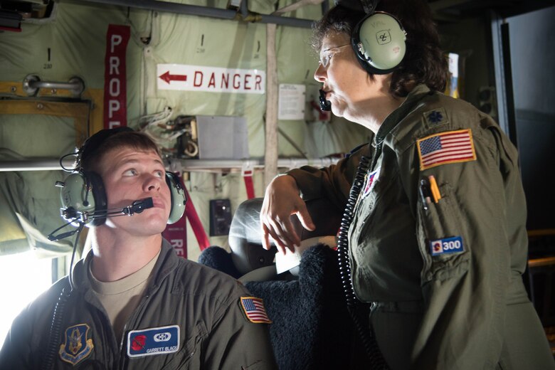 Lt. Col. Valarie Hendry, 53rd Weather Reconnaissance Squadron aerial reconnaissance weather officer, instructs new ARWO, 2nd Lt. Garrett Black, during the final flight of her Air Force Career. (U.S. Air Force photo/Senior Airman Heather Heiney) 