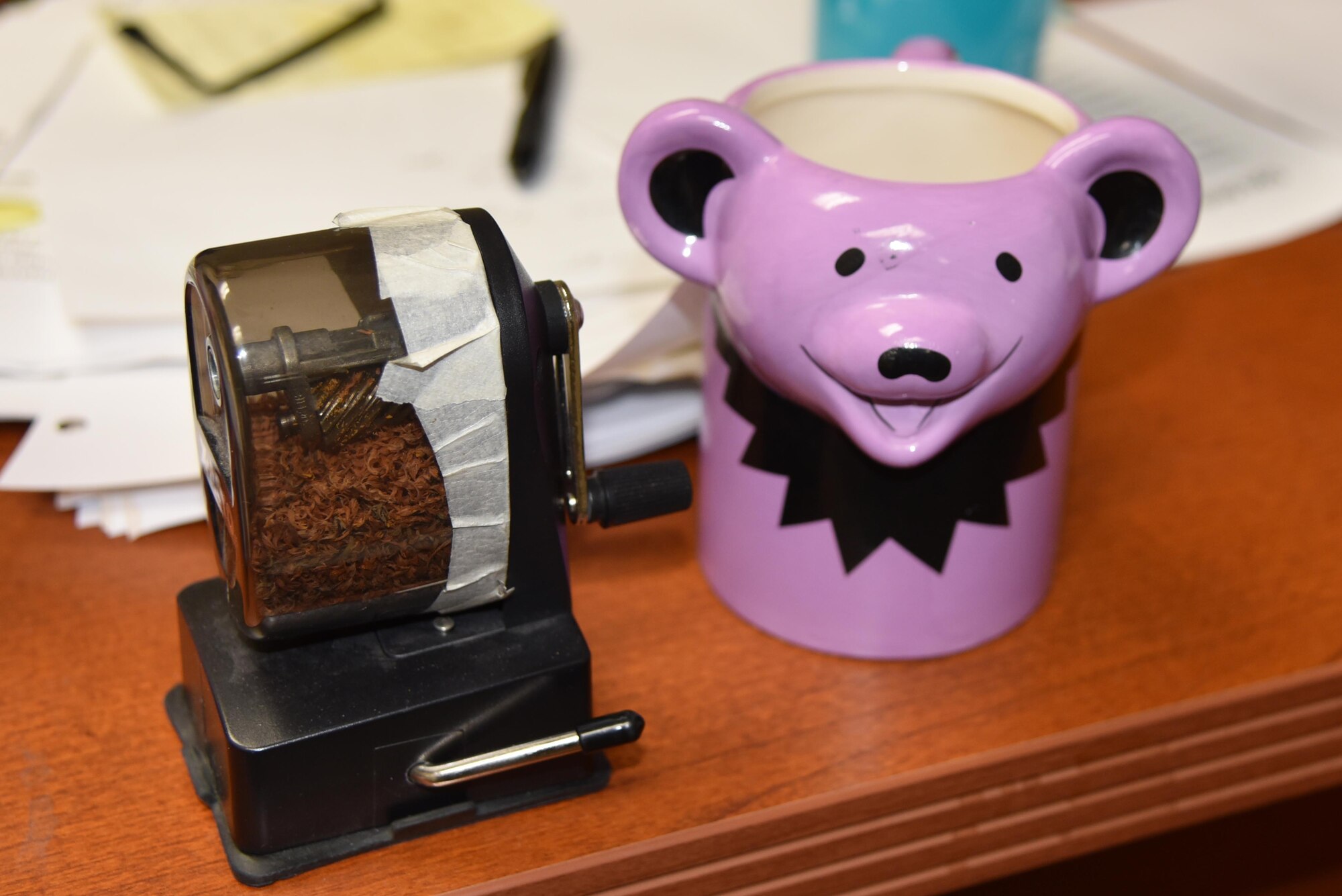 Lt. Col. Troy “Bear” Anderson, 53rd Weather Reconnaissance Squadron pilot decorates his desk with a pencil sharpener and bear mug before his final flight Sept. 26, 2016 at Keesler Air Force Base, Miss. (U.S. Air Force photo/Maj. Marnee A.C. Losurdo)
