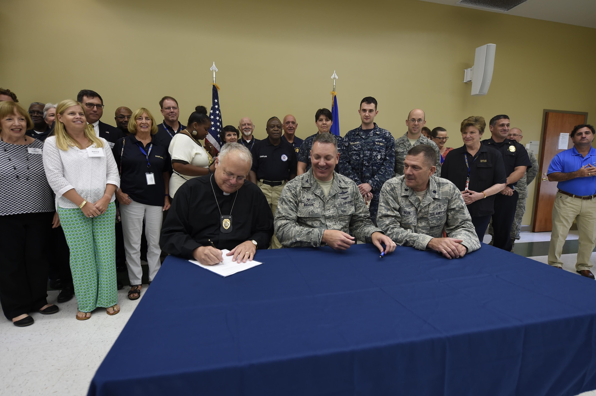 Rev. Rob Duey, Coastal Crisis Chaplaincy chaplain (left), Col. Robert Lyman, 628th Air Base Wing commander (center), and Lt. Col. Walter Bean, 628th ABW chaplain sign a Memorandum of Agreement here Sept. 21, 2016.  The MOA establishes written guidelines between the Joint Base Chaplain's office and the Coastal Crisis Chaplaincy.  This organization provides emergency, crisis intervention and counseling services to local EMS, first responders and other local agencies.  The Coastal Crisis Chaplaincy will collaborate with the JB Charleston Chaplain’s office as part of the chapel’s P4 initiatives. The program establishes local partnerships and bolsters networking and communications between religious officials across the Lowcountry. 