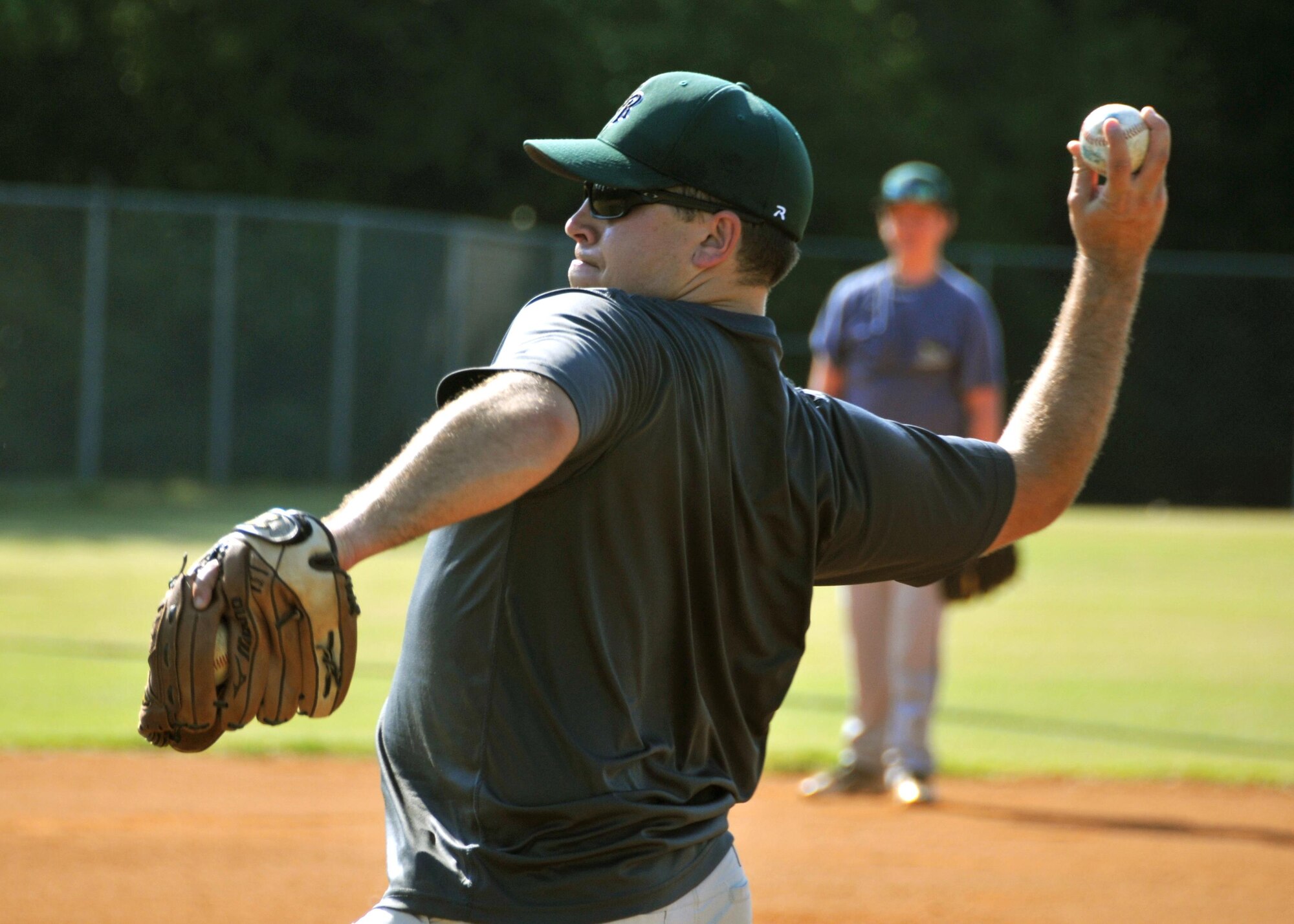 First Lt. Rick Hagauer, a 700th Airlift Squadron pilot, pitches a ball during baseball practice at Hembree Park in Roswell, Ga. on July 2, 2016. Hagauer has a long history of playing baseball that dates back to when he was an adolescent in Peachtree City. (U.S. Air Force photo by Senior Airman Andrew J. Park) 