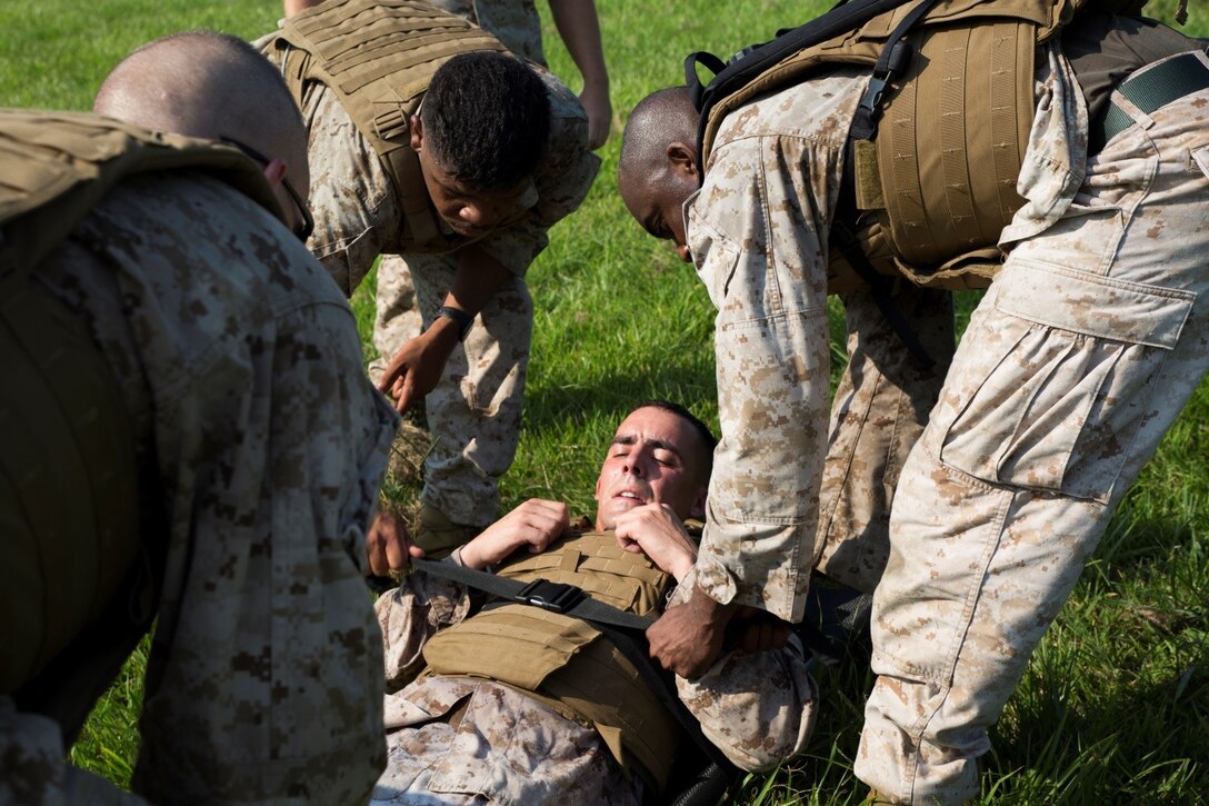 Marines in Corporals Course 4-16 load a casualty on to a litter during a casualty and resupply run at Marine Forces Reserve, Sept. 28, 2016. Throughout the run, Marines took simulated enemy contact and had to react quickly and efficiently to ensure the casualties were transported safely to the end point. The Marines had to work together to problem solve and motivate each other to accomplish the mission. (U.S. Marine Corps photo by Cpl. Melissa Martens) 