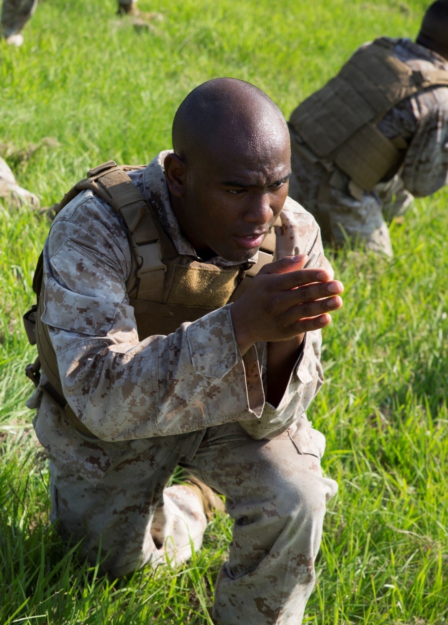 Cpl. Deionte J. Stancil, administration specialist in the Installation Personnel Administration Center, Headquarters Battalion, Marine Forces Reserve, provides cover to a casualty on a resupply run during Corporals Course 4-16 at MARFORRES, Sept. 28, 2016. Throughout the run, Marines carried ammo cans, water jugs and casualties, and had to react quickly when they took simulated enemy contact. (U.S. Marine Corps photo by Cpl. Melissa Martens/ Released) 