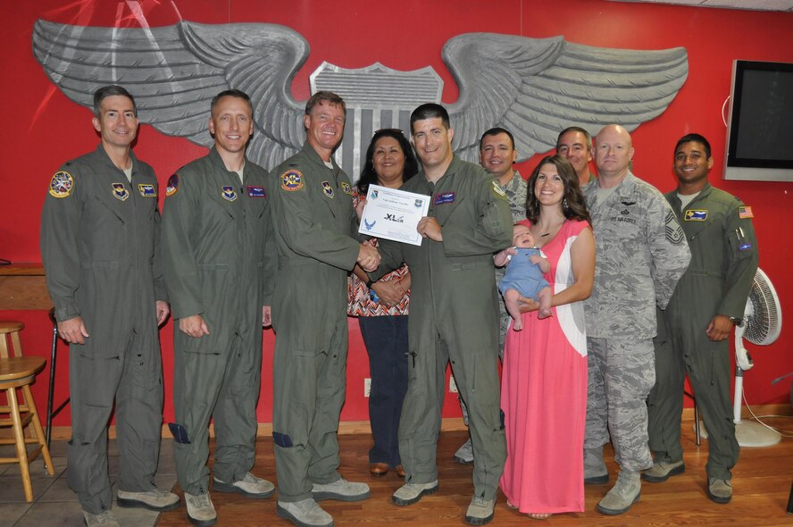 Capt. Anthony Viccellio, 434th Flying Training Squadron Transition Flight chief (front center), accepts the “XLer of the Week” award from Col. Thomas Shank (front left), 47th Flying Training Wing commander, on Laughlin Air Force Base, Texas, Sept. 22, 2016. The XLer is a weekly award chosen by wing leadership and is presented to those who consistently make outstanding contributions to their unit and Laughlin. (U.S. Air Force photo/1st Lt. Isabel Crump)