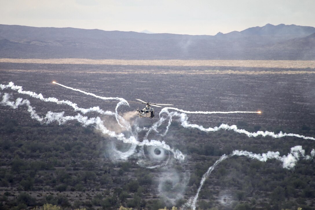 A UH-1Y Venom fires flares during Weapons and Tactics Instructor Course 1-17 at the Chocolate Mountain Aerial Gunnery Range in California, Sept. 28, 2016. Marine Aviation Weapons and Tactics Squadron 1 personnel host the seven-week training exercise. Marine Corps photo by Staff Sgt. Artur Shvartsberg