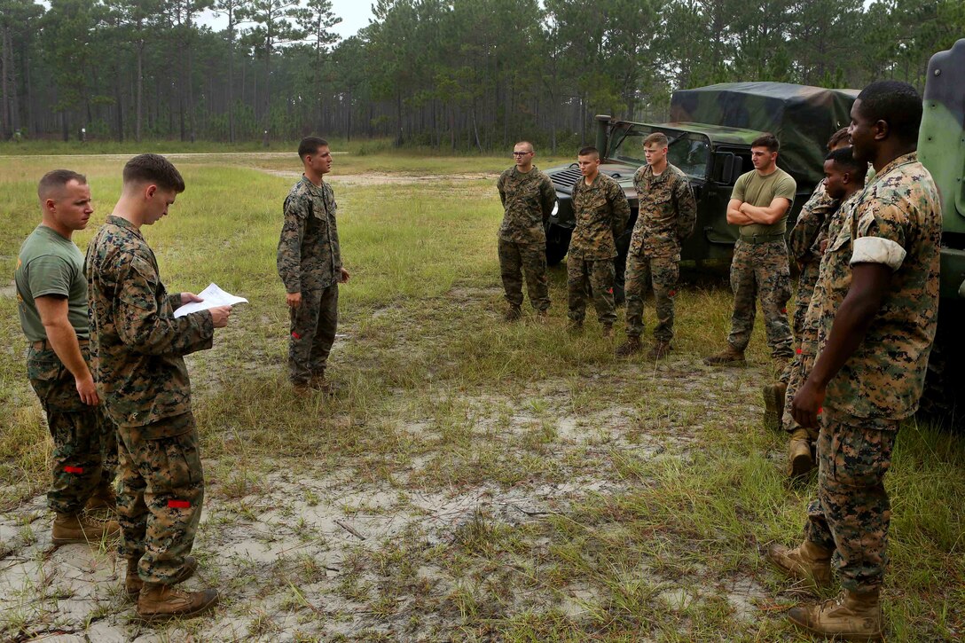 Marine Corps Cpl. Jacob Scheid, left, briefs Marines on safety procedures during helicopter hoist training at Condor landing zone at Camp Lejeune, N.C., Sept. 20, 2016. Scheid is assigned to Combat Logistics Battalion 26, Headquarters Regiment, 2nd Marine Logistics Group. The Marines trained to increase their skills at hooking up external loads to military helicopters that transport gear and supplies. Marine Corps photo by Lance Cpl. Jack A. E. Rigsby