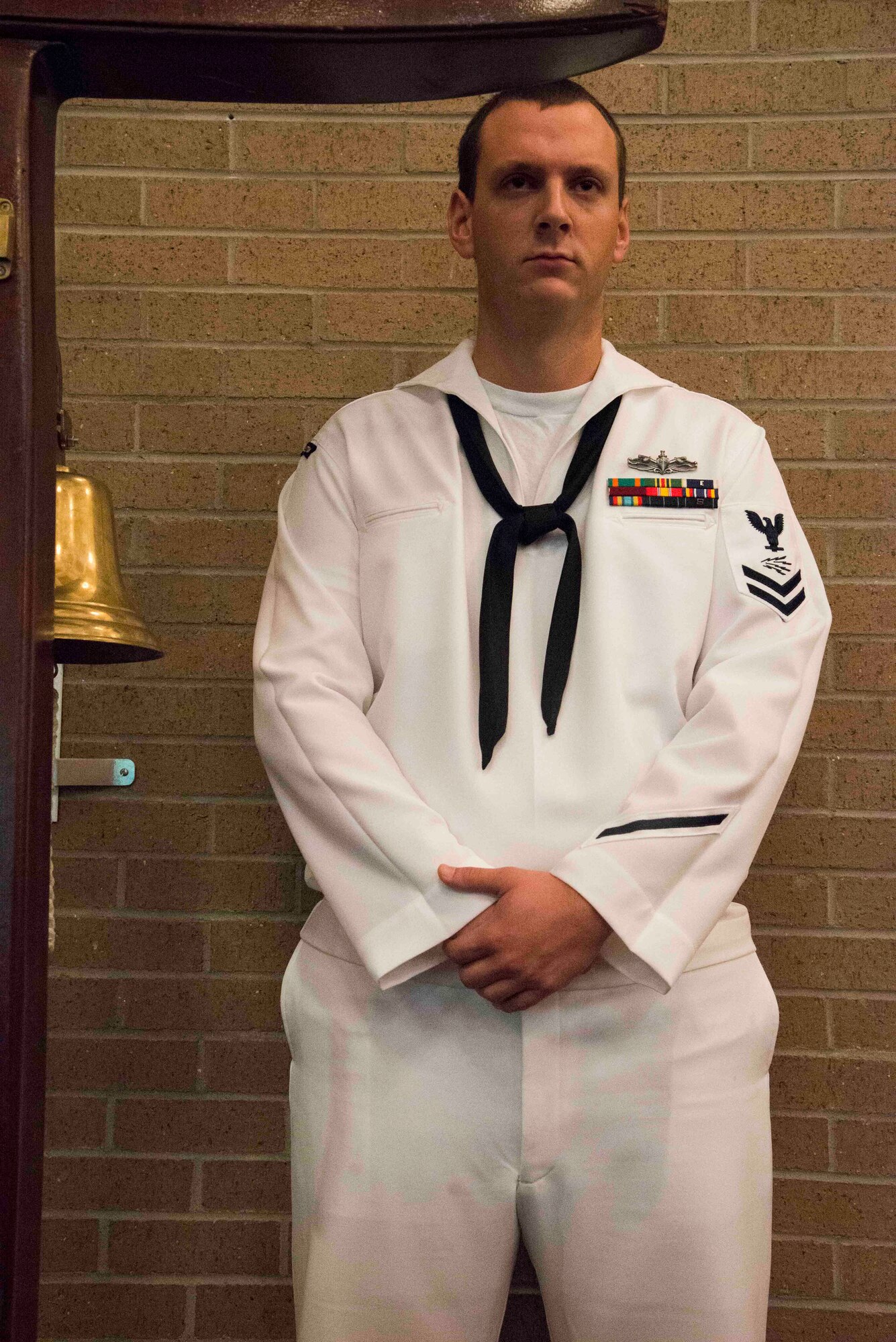 Information Systems Technician Second Class Michael Haskin stands by to ring the ceremonial bell at the inaugural "Bells Across America" ceremony at All Saints Chapel on Joint Base Charleston-Naval Weapons Station September 22, 2016. Bells Across America is a ceremony that honors fallen servicemembers and is held each year on military installations around the world in conjunction with Gold Star Mothers and Families' Day.