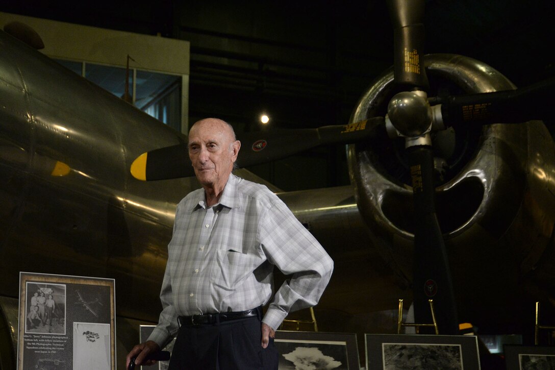 U.S. Army Air Corps World War II veteran Milton Dienes stands in front of a display of photos at the National Museum of the U.S. Air Force on Wright-Patterson Air Force Base, Ohio, Sept. 23, 2016. The photos  include images he captured and processed of the atomic bombings on Japan by the B-29 bomber Bock’s Car. During the war, Dienes served in the 9th Photographic Technical Squadron which was responsible for processing imagery captured during and after the time of the atomic strikes on Hiroshima and Nagasaki, Japan. Dienes was on the ground, documenting the damage three months after “Fat Man” was dropped on Nagasaki. (U.S. Air Force Photo/Master Sgt. Tammie Moore) 