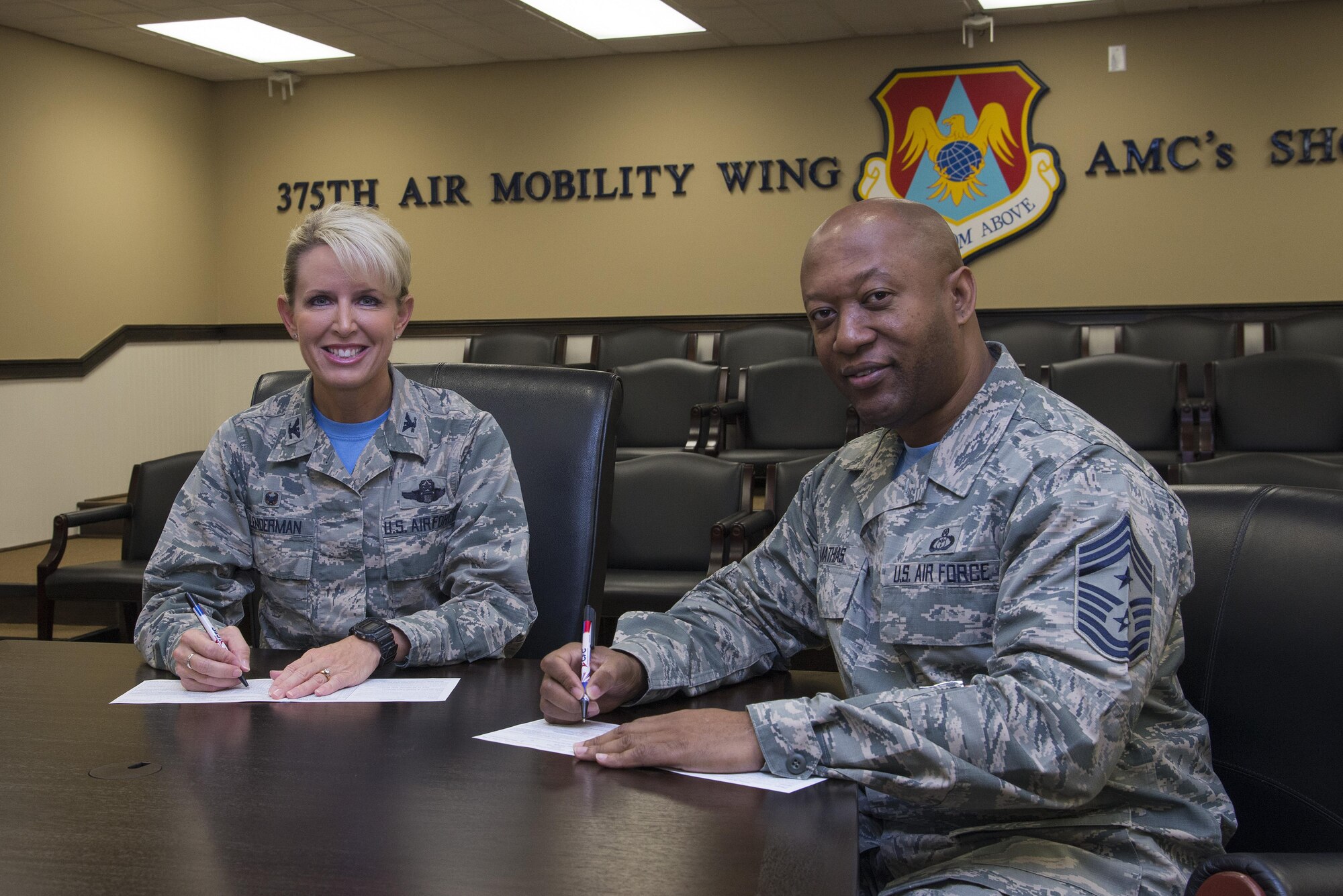 Col. Laura Lenderman, 375th Air Mobility Wing commander, and CMSgt. Wesley Mathias, 375th AMW command chief, kick off the 2016 Combined Federal Campaign by making personal donations.  The contributions of federal, military and postal employees have generated more than $8 billion since its creation in 1964. (U.S. Air Force photo by Airman 1st Class Gwendalyn Smith)