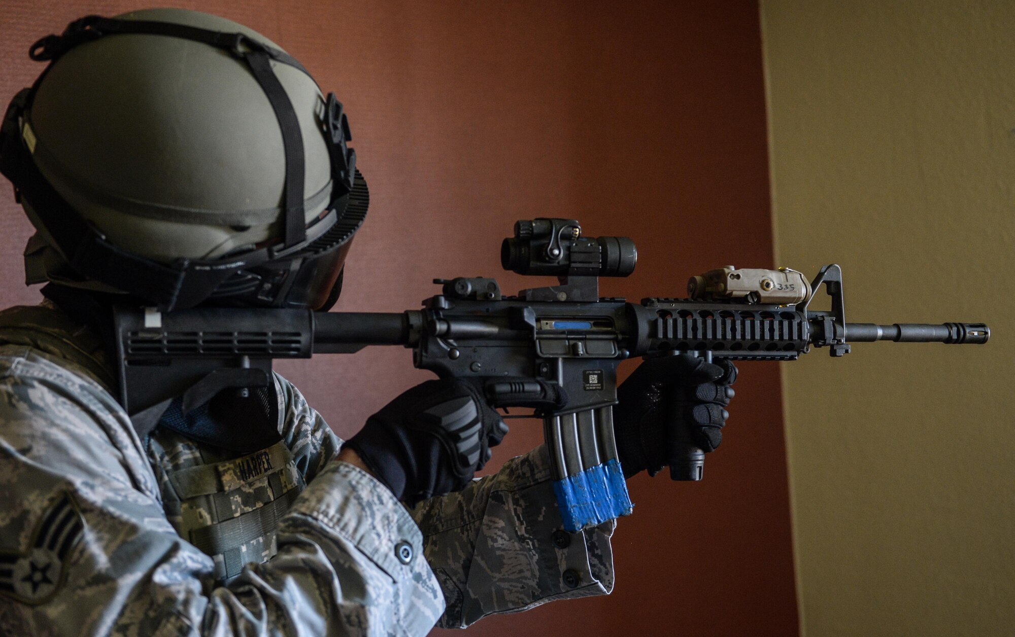 Senior Airman Kyle Harper, 2nd Security Forces Squadron entry controller, sights his rifle at Barksdale Air Force Base, La., July 18, 2016. During the training, defenders cleared the building room by room, looking for the shooter. Once all threats had been neutralized, the teams execute a second building sweep to make sure no threats were left behind. (U.S. Air Force photo/Senior Airman Curt Beach)