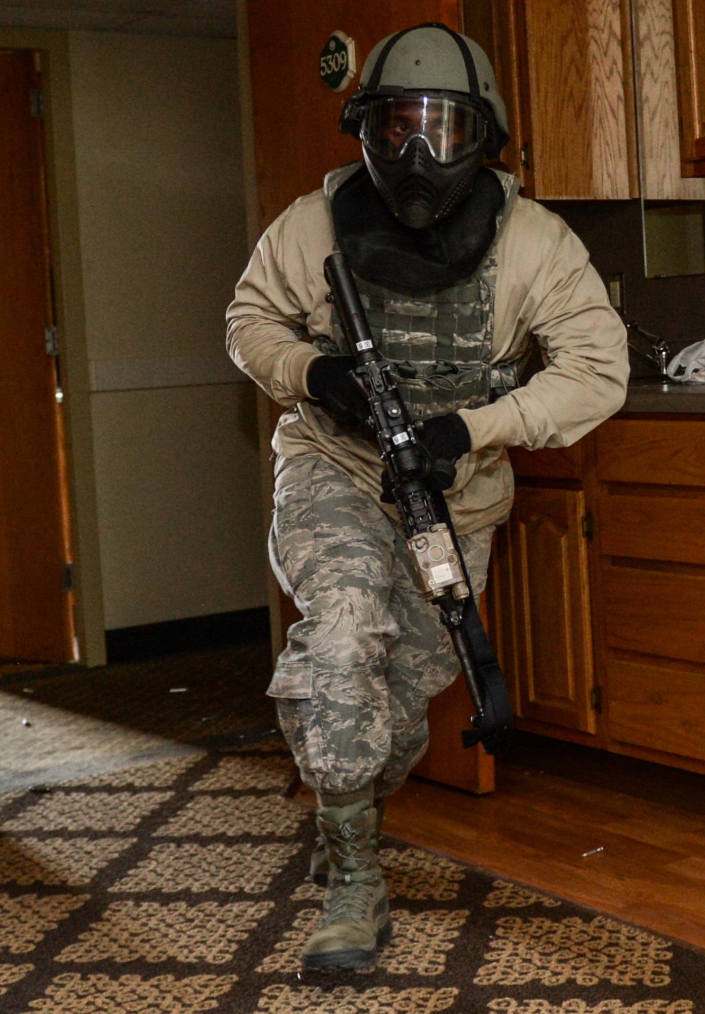 A defender from the 2nd Security Forces Squadron charges into a room during an active shooter training exercise at Barksdale Air Force Base, La., July 18, 2016. During the training, defenders cleared the building room by room, looking for the shooter. Once all threats had been neutralized, the teams conducted a second building sweep to make sure no threats were left behind. (U.S. Air Force photo/Senior Airman Curt Beach)