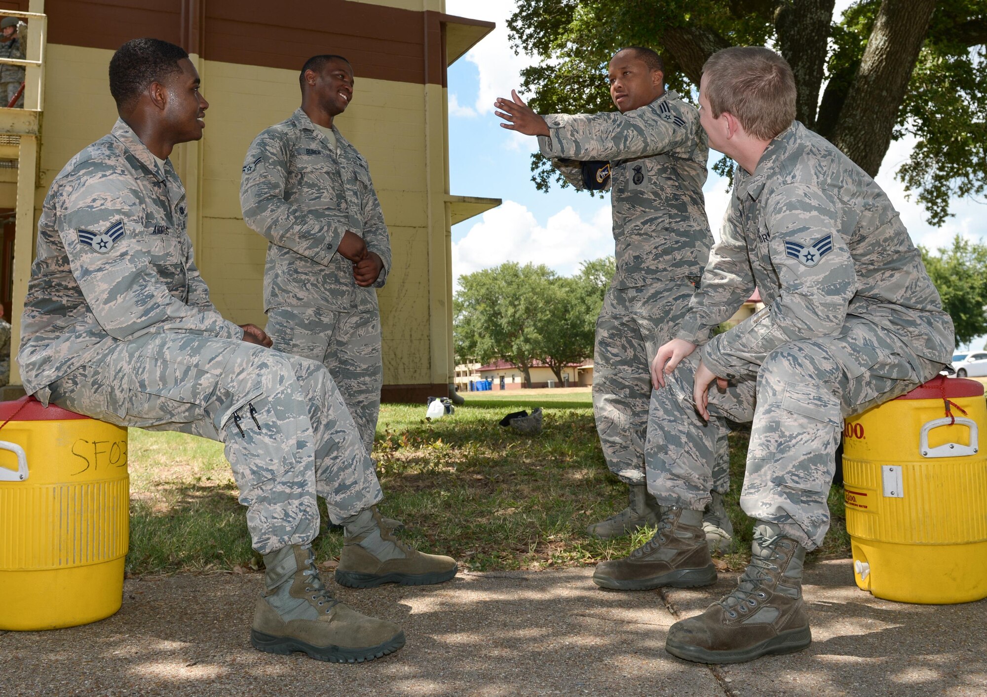 Airmen from the 2nd Security Forces Squadron, discuss tactics for clearing a building during an active shooter training exercise at Barksdale Air Force Base, La., July 18, 2016. The squadron conducted the training in teams of two, rather than their usual four-person teams, because a typical team responding to a real-world situation consists of two Airmen. (U.S. Air Force photo/Senior Airman Curt Beach)