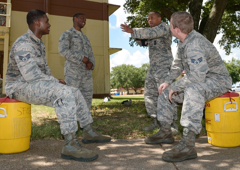 Airmen from the 2nd Security Forces Squadron, discuss tactics for clearing a building during an active shooter training exercise at Barksdale Air Force Base, La., July 18, 2016. The squadron conducted the training in teams of two, rather than their usual four-person teams, because a typical team responding to a real-world situation consists of two Airmen. (U.S. Air Force photo/Senior Airman Curt Beach)