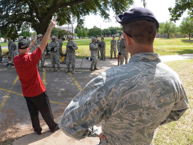 Patrick Pollard, 2nd Security Forces Squadron chief of training, relays instructions to a team of defenders at Barksdale Air Force Base, La., July 18, 2016. The 2nd SFS conducted an active shooter exercise where the objective was to locate and neutralize the shooter as soon as possible, while limiting potential casualties. (U.S. Air Force photo/Senior Airman Curt Beach)