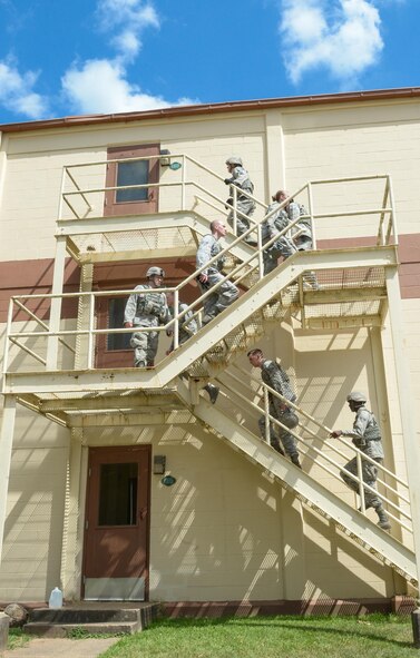 Airmen from the 2nd Security Forces Squadron climb to the top floor of a building to begin an active shooter exercise at Barksdale Air Force Base, La., July 18, 2016. During the training, defenders cleared the building room by room, looking for the shooter. Once all threats had been neutralized, the teams performed a second building sweep to make sure no threats remained. (U.S. Air Force photo/Senior Airman Curt Beach) 