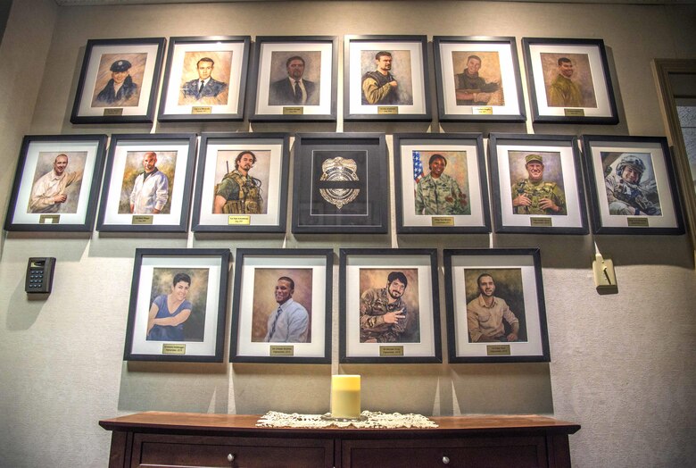 The memory of six fallen heroes killed Dec. 21, 2015 by a suicide bomber near Bagram Air Field, Afghanistan is still strong at the Air Force Office of Special Investigation headquarters at Scott Air Force Base, Ill. The four OSI special agents, Micahel A. Cinco, Chester J. McBride, Peter W. Taub and Adrianna M. Vorderbruggen; and two Security Forces defenders, now honorary special agents, Tech. Sgt. Joseph G. Lemm and Staff Sgt. Louis M. Bonacasa, had their Hall of Heroes portraits added to the wall alongside 10 previous fallen heroes. (U.S. Air Force photo by Airman Daniel Garcia)
