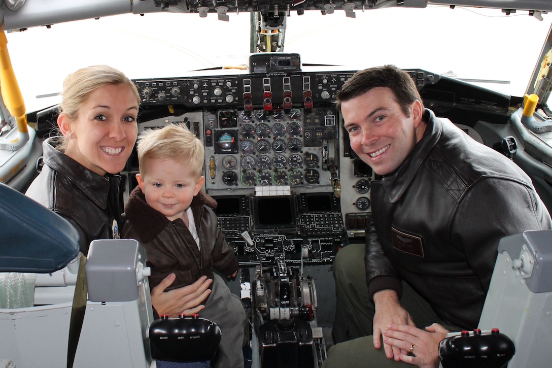 Air Force Capt. Chrystina Jones, 350th Air Refueling Squadron pilot, left, and Air Force Maj. Matt Jones, 349th ARS pilot, pose with their son at McConnell Air Force Base, Kan., in December 2015. The couple once flew the C-130 Hercules, but currently “refuel the fight” as KC-135 Stratotanker pilots, an aircraft that first took flight 60 years ago. Courtesy photo