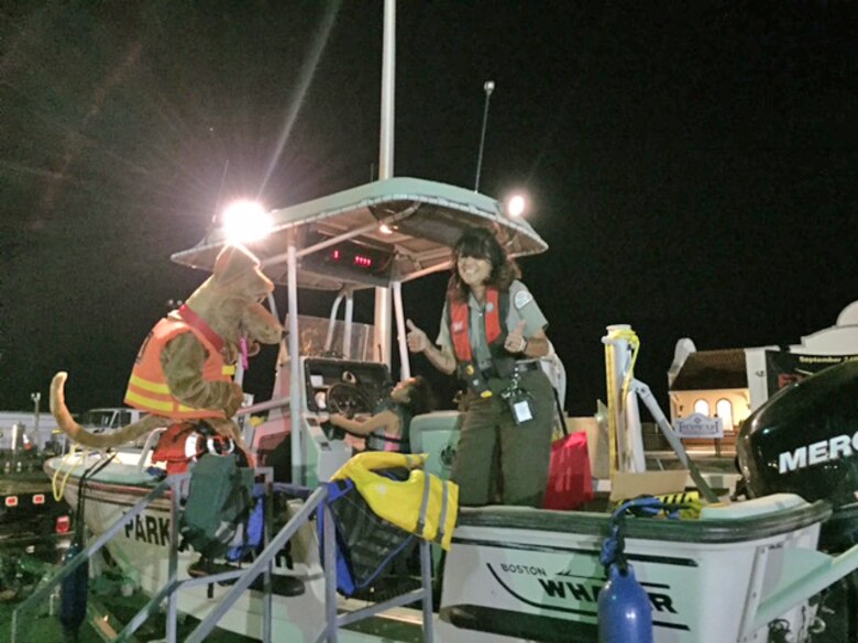 TUCUMCARI, N.M., -- Conchas Lake park ranger Nadine Carter gives the “thumbs up” as Bobber the Water Safety Dog gives advice to a young boater at the lake’s display at the Fired Up event, Sept. 24, 2016. The event focused on water safety.