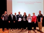 Representatives from the Ogden Air Logistics Complex accept the 2016 Department of Defense Voluntary Protection Program Group Achievement Award during the National Voluntary Protection Programs Participants' Association conference in Kissimmee, Florida. From the left are: William Hood, OO-ALC VPP Program Manager; Vance Lineberger, AFMC HQ/Safety; Len Litton, Director, Personnel Risk Reduction; Brig. Gen. Steven Bleymaier, Commander, Ogden Air Logistics Complex; Sandra Fitzgerald, Director, 309th Electronics Maintenance Group; Laura Haislip, 309th Electronics Maintenance Group Union Steward/Employee; Maureen Sullivan, Deputy Assistant Secretary of Defense, Environment, Safety and Occupational Health; and Joseph Blue, OO-ALC Union Safety/VPP Representative. 