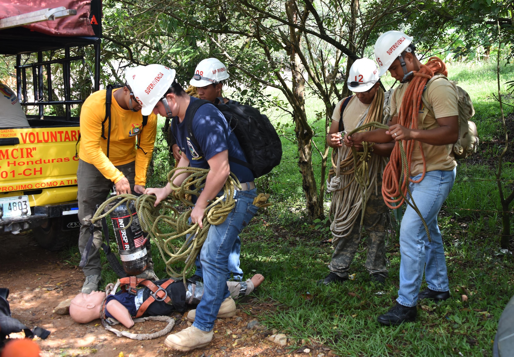 Honduran PUMCIR (Personal Utilizado en Misiones Contra Incendio y Rescate – Personnel Used in Fire and Rescue) volunteers prepare the ropes, SCUBA tanks and “Bartholomew” the 50-pound dummy they would use to conduct cave extraction search and rescue training in the Comayagua National Park near El Volcan, Honduras, Sept. 24, 2016. A number of the PUMCIR members on this particular exercise were part of the PUMCIR ELITE-RESCUE team. (U.S. Air Force photo by Capt. David Liapis)