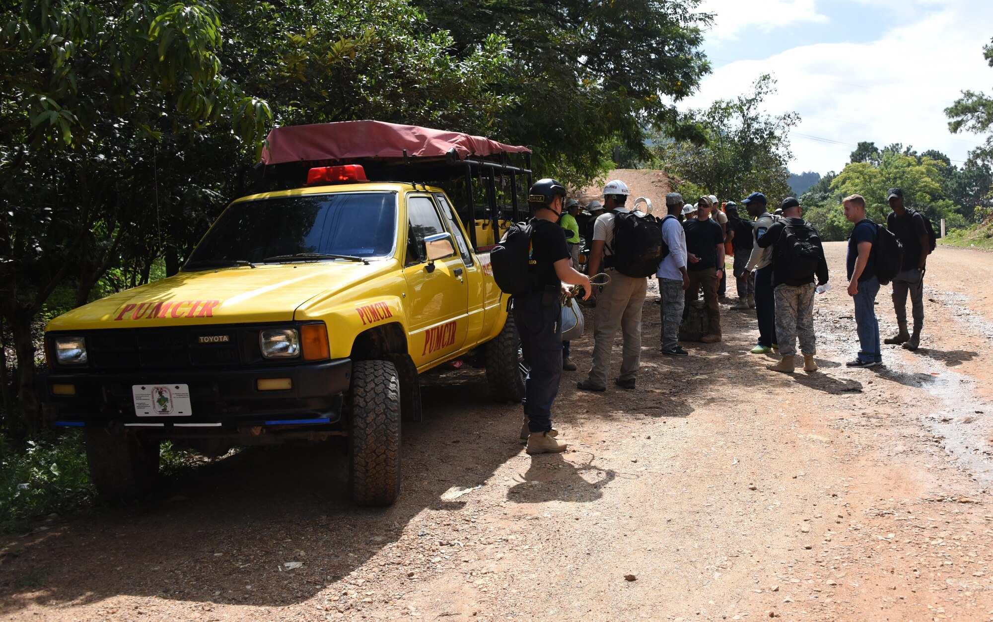 Nearly a dozen Honduran PUMCIR (Personal Utilizado en Misiones Contra Incendio y Rescate – Personnel Used in Fire and Rescue) volunteers and seven U.S. Air Force Airmen assigned to Joint Task Force-Bravo at Soto Cano Air Base, Honduras, await the final go-ahead from PUMCIR instructor and founder Herberth Gaekel to begin a search and rescue exercise in the Comayagua National Park near El Volcan, Honduras, Sept. 24, 2016. Gaekel, who also works as the 612th Air Base Squadron Fire Department liaison at Soto Cano AB, founded the PUMCIR in 1994 after learning of a tragic story involving the loss of life that might have been prevented had there been search and rescue capabilities in the area. (U.S. Air Force photo by Capt. David Liapis)