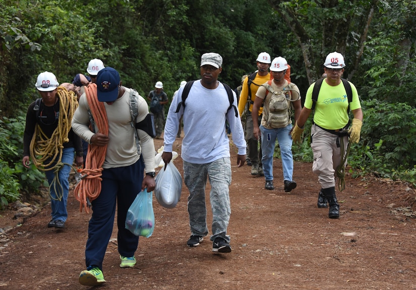 U.S. Air Force Airmen from the 612th Air Base Squadron at Soto Cano Air Base, Honduras, join Honduran PUMCIR (Personal Utilizado en Misiones Contra Incendio y Rescate – Personnel Used in Fire and Rescue) volunteers for search and rescue training in Comayagua National Park near El Volcan, Honduras, Sept. 24, 2016. In addition to the gear required for the exercise scenario, such as ropes, stretchers and safety gear, the team carried clothes, shoes and toys to hand out along the way to locals in need of material assistance. (U.S. Air Force photo by Capt. David Liapis)