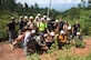 Thirteen Honduran PUMCIR (Personal Utilizado en Misiones Contra Incendio y Rescate – Personnel Used in Fire and Rescue) volunteers and six U.S. Air Force Airmen assigned to Joint Task Force-Bravo who included firefighters and Personnel Recovery Coordination Cell members, led by Herberth Gaekel (left), 612th Air Base Squadron Fire Department liaison at Soto Cano Air Base, Honduras, and PUMCIR founder and instructor, pose for a photo midway through a three-mile hike up to a cave located in Comayagua National Park near El Volcan, Honduras, Sept. 24, 2016, to conduct search and rescue training. Gaekel seeks to involve U.S. service members in order to provide them an opportunity to share with and learn from their Honduran counterparts as well as to encourage positive relationship building between the two nations. Gaekel said the training he provides significantly augments what training the volunteers, who are also often full or part-time Bomberos, already receive, and in many cases would not receive if not for his program. (U.S. Air Force photo by Capt. David Liapis) 