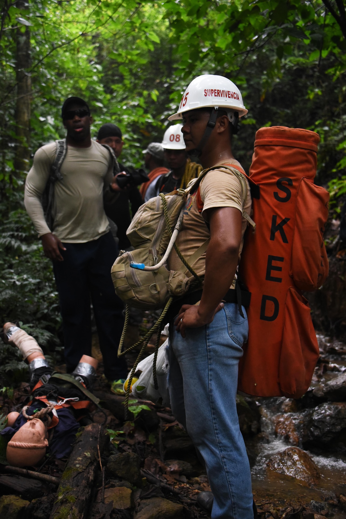 Honduran PUMCIR (Personal Utilizado en Misiones Contra Incendio y Rescate – Personnel Used in Fire and Rescue) volunteer carrying a roll-up stretcher rests along a creek in Comayagua National Park near El Volcan, Honduras, Sept. 24, 2016 while on a six-mile round-trip hike to a cave to conduct search and rescue training. He was accompanied by a dozen other PUMCIR volunteers and seven U.S. Air Force Airmen assigned to Joint Task Force-Bravo at Soto Cano Air Base, Honduras, and Herberth Gaekel, PUMCIR instructor and founder. (U.S. Air Force photo by Capt. David Liapis)