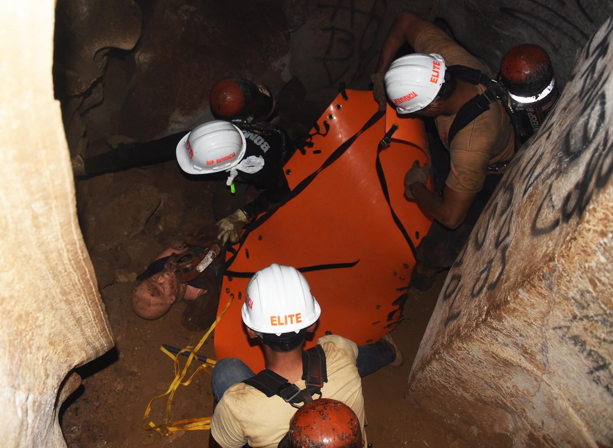 Honduran PUMCIR (Personal Utilizado en Misiones Contra Incendio y Rescate – Personnel Used in Fire and Rescue) volunteers prepare to remove “Bartholomew,” a 50-pound training dummy on a roll-up stretcher from inside a cave in the Comayagua National Park near El Volcan, Honduras, Sept. 24, 2016 during search and rescue training. Three groups of trainees were given five minutes from the time they entered the cave to safely extract the “victim” from more than 150 feet inside the mountain. (U.S. Air Force photo by Capt. David Liapis)