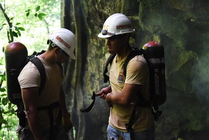 Honduran PUMCIR (Personal Utilizado en Misiones Contra Incendio y Rescate – Personnel Used in Fire and Rescue) volunteers prepare to leave their search and rescue training site at a large cave in Comayagua National Park near El Volcan, Honduras, Sept. 24, 2016. The training involved extracting a 50-pound dummy from the cave on a roll-up stretcher in under five minutes while wearing SCUBA tanks and other necessary safety gear in order to simulate a real-world scenario. (U.S. Air Force photo by Capt. David Liapis)
