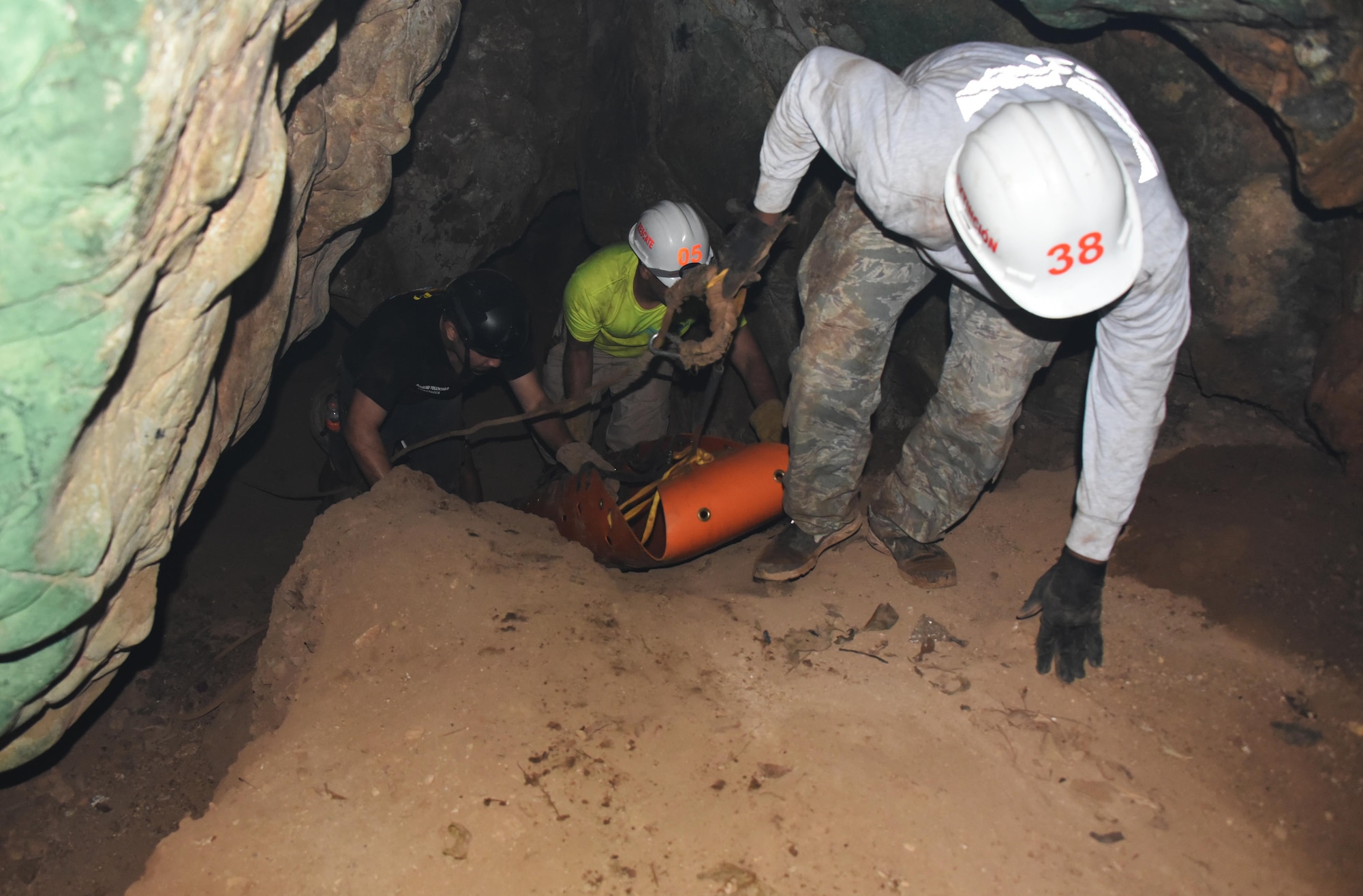 Honduran PUMCIR (Personal Utilizado en Misiones Contra Incendio y Rescate – Personnel Used in Fire and Rescue) volunteers and a U.S. Air Force Airman assigned as a firefighter with the 612th Air Base Squadron at Soto Cano Air Base, Honduras, pull a roll-up stretcher carrying “Bartholomew,” a 50-pound dummy, from the mouth a cave during search and rescue training in Comayagua National Park near El Volcan, Honduras, Sept. 24, 2016. Herberth Gaekel, 612th ABS Fire Department liaison and PUMCIR) founder and instructor seeks to involve U.S. service members in the training in order to provide them an opportunity to share with and learn from their Honduran counterparts as well as to encourage positive relationship building between the two nations. (U.S. Air Force photo by Capt. David Liapis)