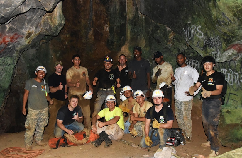 Honduran PUMCIR (Personal Utilizado en Misiones Contra Incendio y Rescate – Personnel Used in Fire and Rescue) volunteers and U.S. Air Force Airmen assigned to Joint Task Force-Bravo, including firefighters and Personnel Recovery Coordination Cell members, led by Herberth Gaekel, 612th Air Base Squadron Fire Department liaison at Soto Cano Air Base, Honduras, and PUMCIR founder and instructor, pose for a photo after completing cave extraction search and rescue training in Comayagua National Park near El Volcan, Honduras, Sept. 24, 2016. Gaekel, who has been a key factor in the success of CENTAM SMOKE (Central America Sharing Mutual Operational Knowledge and Experience), a bi-annual exercise for Bomberos held at Soto Cano, has invited U.S. service members to join in the PUMCIR training for the past ten years in order to provide them an opportunity to share with and learn from their Honduran counterparts as well as to encourage positive relationship building between the two nations. (U.S. Air Force photo by Capt. David Liapis) 